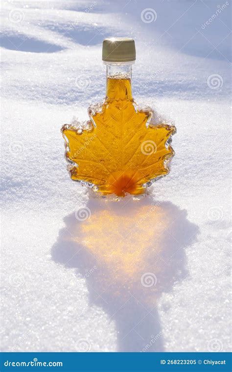 Maple Leaf Shaped Bottle Filled with Golden Maple Syrup Sitting on ...