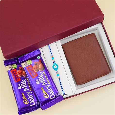 Send Evil Eye Rakhi with Cushion Gift Hamper Online