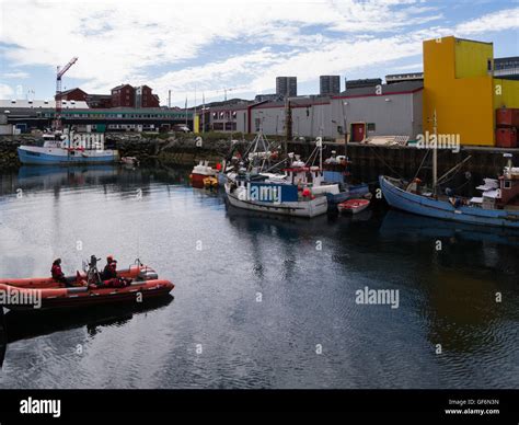 Fishing boats in Nuuk harbour capital city of Greenland and country's largest cultural and ...