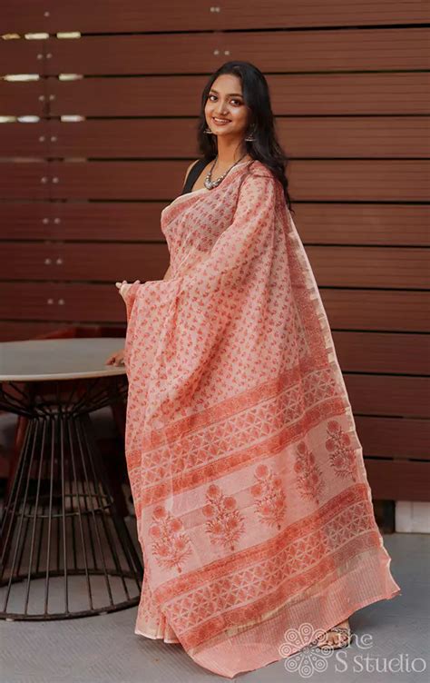 Shop peach kota cotton saree with floral print and zari border