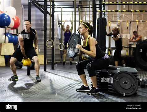 People circuit training in gym Stock Photo - Alamy