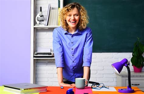 School teacher or university professor sitting at desk in classroom and ...