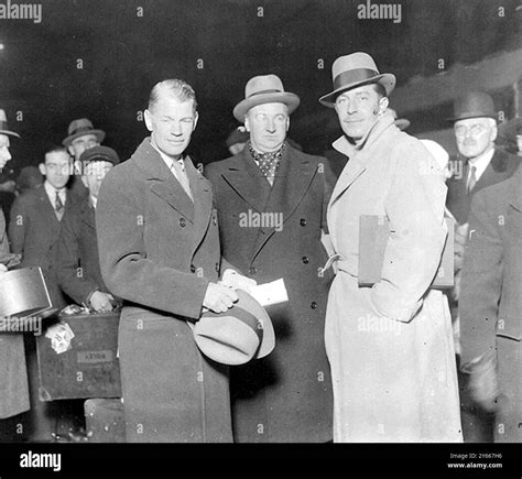 English film director , James Whale , on left without hat on arrival at Waterloo Station ...