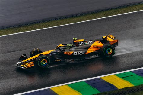 High-speed Formula 1 Car on Wet Track · Free Stock Photo