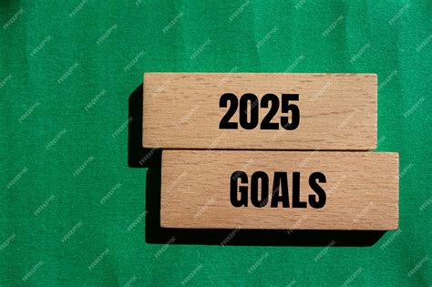 Premium Photo | 2025 goals message written on wooden blocks with green ...