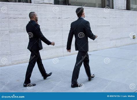 People Walking in Suits 的图像结果