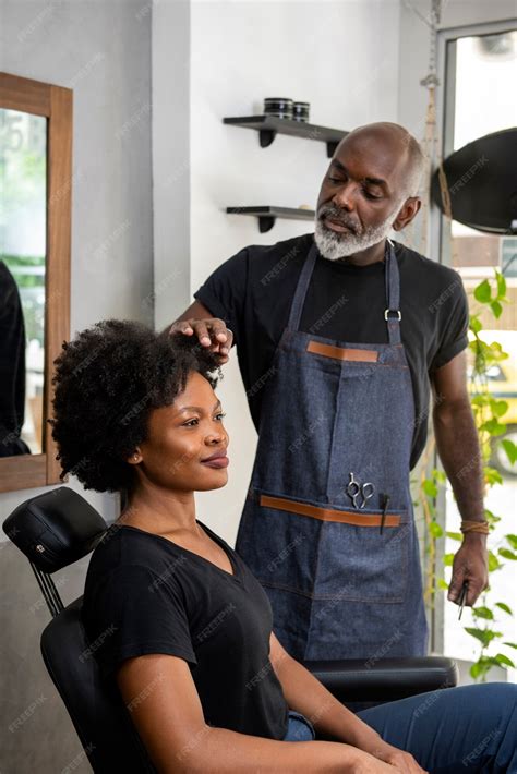 Free Photo | Latino hair salon owner taking care of client