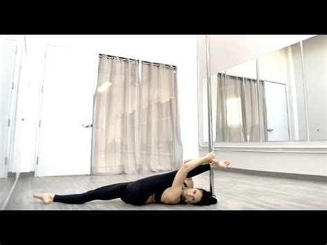 a woman is doing an acrobatic pose on the floor