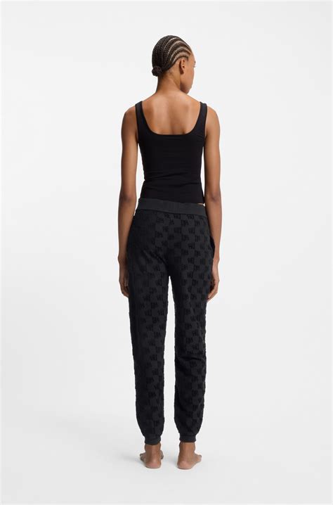 HUGO - Cotton-blend tracksuit bottoms with all-over logo pattern - Black