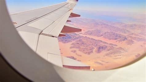 Airplane window view with beautiful textures and landscape of wadi rum ...