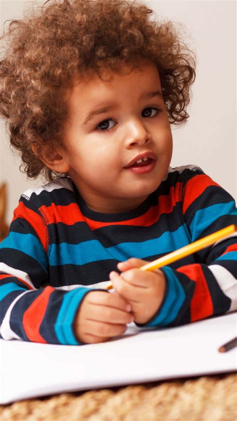 Download Adorable Boy Drawing With Pencil Wallpaper | Wallpapers.com