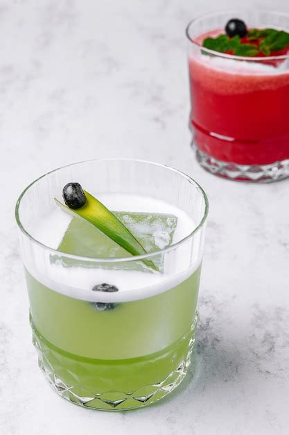 Lime and strawberry cocktails with big piece of ice | Premium Photo