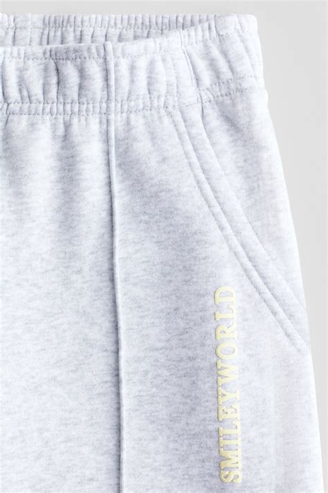 Print-motif sweatshirt joggers - Light grey/SmileyWorld® - Kids | H&M IN