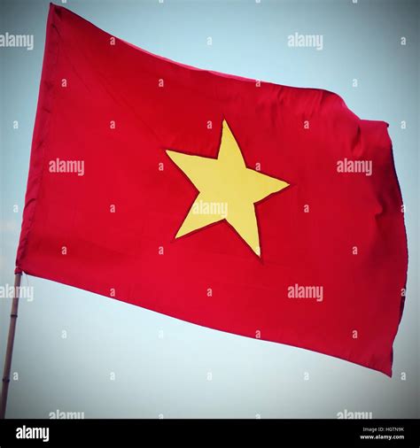 waving red flag of VIETNAM with the big yellow star waving Stock Photo ...