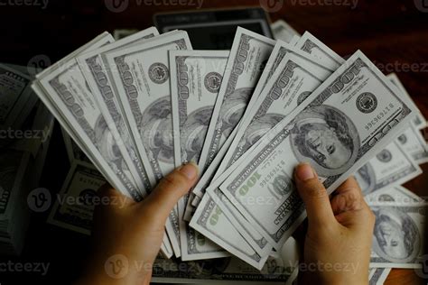 Hands holding money banknote 100 usd 2473993 Stock Photo at Vecteezy
