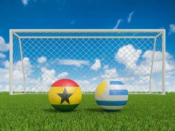 Footballs in flags colors on soccer field ghana with uruguay 3d ...