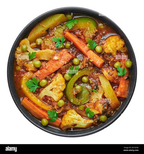 Veg Kolhapuri in black bowl isolated on white. Indian vegetable curry ...