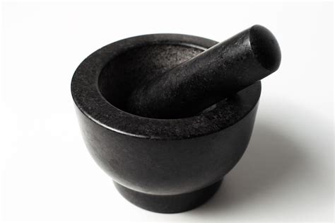 Closeup of granite stone grinder bowl of black on white background ...