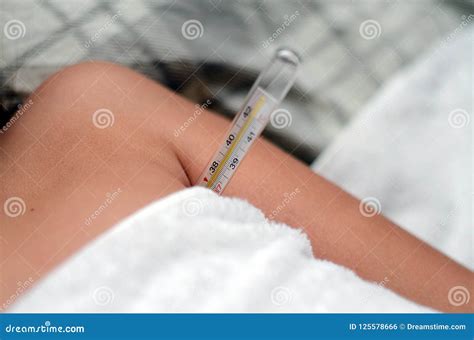 Body Temperature Measurement with a Thermometer Stock Photo - Image of ...