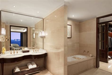 The Ritz-Carlton bath mat hung over standing bathtub