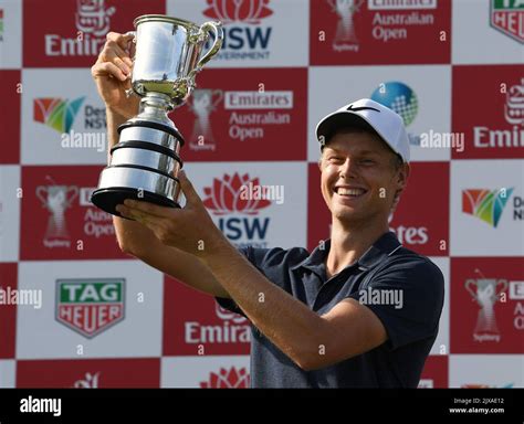 Cameron Davis of Australia poses for photographers while holding The Stonehaven Cup after ...