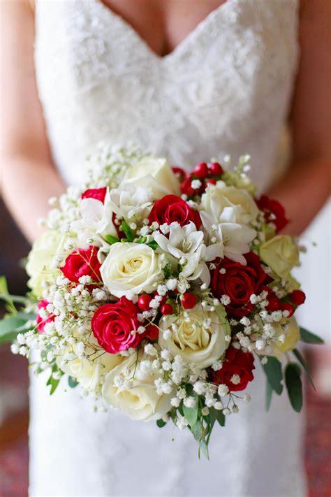 white and red bridal bouquet of beautiful roses , baby's breath and ...