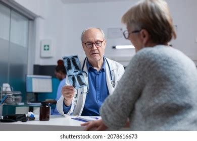Image of a doctor and a patient reviewing a scan.