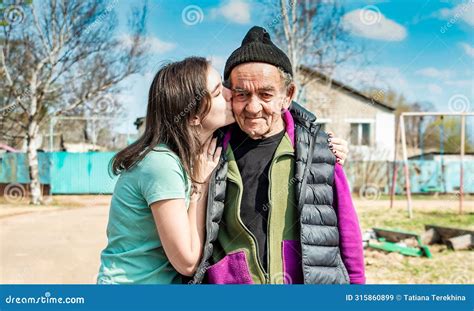 Portrait of Granddaughter Kissing in Cheek Her 75 Years Old Grandfather ...