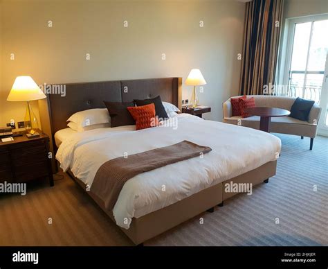 Modern bedroom with bed and sofa Stock Photo - Alamy