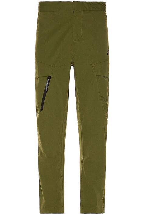Nike Utility Pant Cropped in Rough Green & Black | REVOLVE