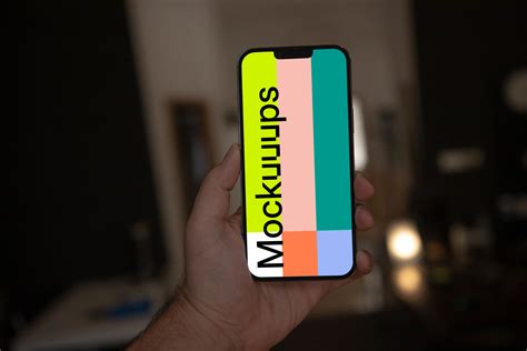 Hand holding iPhone 13 Pro mockup - Mockuuups Studio