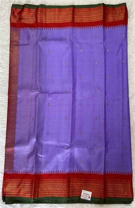 Gadwal Pattu Saree Lavender colored saree complemented with a Red Kanc ...