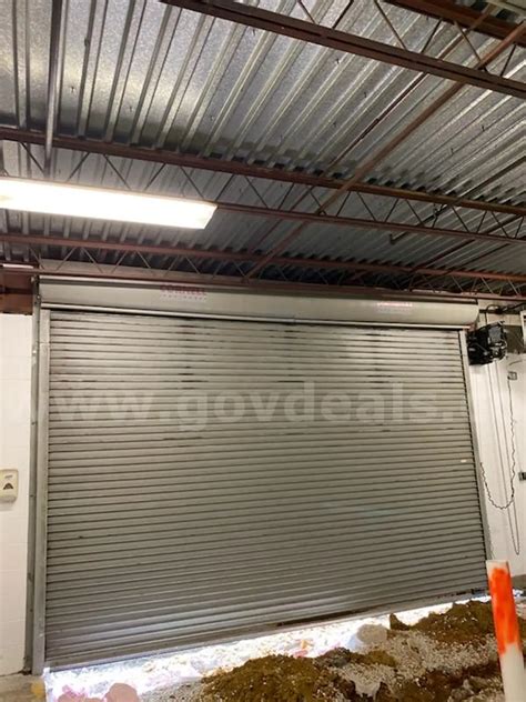 Sally port Garage Door 16 ft 6 1/4 inch wide 12 foot tall | AllSurplus