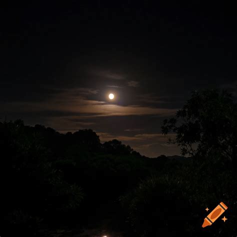 Full moon shines over a dark landscape of trees and hills under a ...