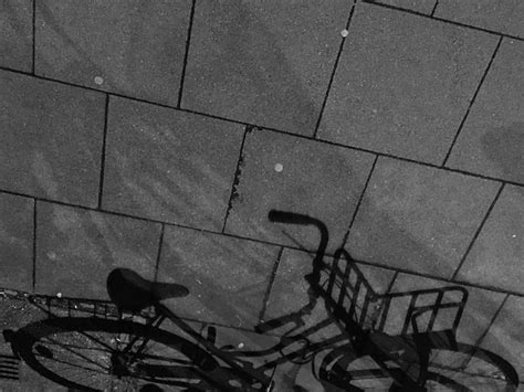 High angle view of bicycle shadow on footpath | Premium Photo
