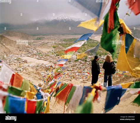 View through Buddhist prayer flags over capital Leh, Indus valley ...