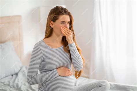 Premium Photo | Pregnant woman feeling nauseous in bedroom