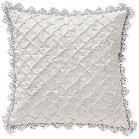 a white pillow with tasselled edges