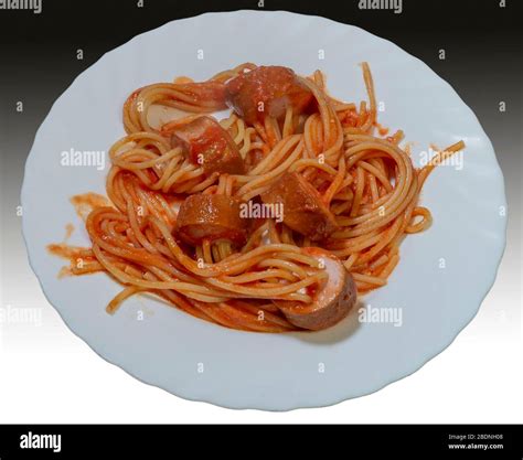 A plate of frankfurter hot dog spaghetti, with spaghetti tucked into ...