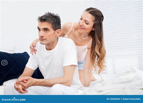 Woman Seducing Pensive Man in Bed Stock Photo - Image of crisis, affair ...