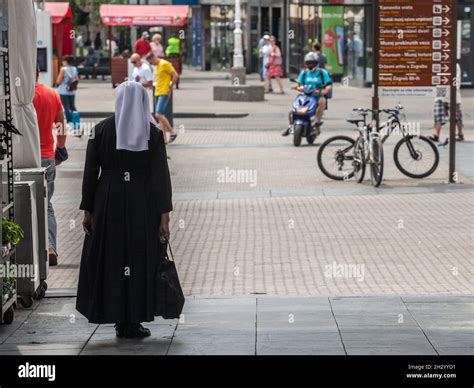 Picture of a nun walking in the historical center of Zagreb Croatia. Catholic religion and ...