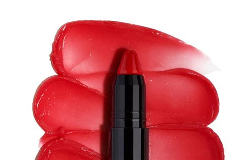 A closeup shot of a red lipstick on lips gloss strokes isolated ...