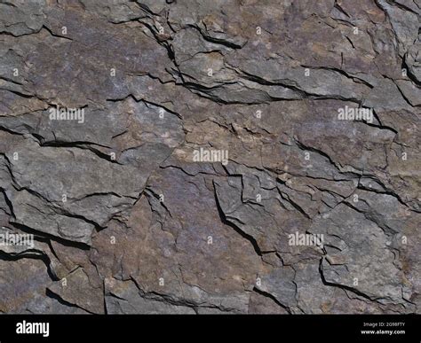 Close-up view of slate (also shale, schist) with visible cracked layers ...