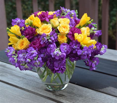 Everyday flowers in a vase: purple stock, yellow roses, yellow freesia ...