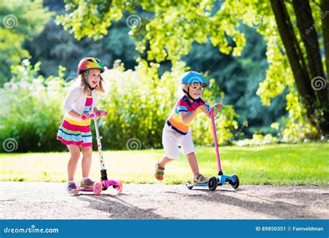 Kids Riding Scooter in Summer Park. Stock Image - Image of group ...