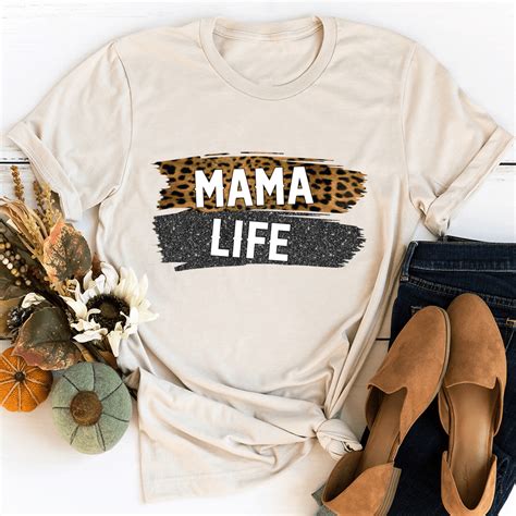 https://www.peachysunday.com/cdn/shop/products/mama-life-tee-heather-dust-s-peachy-sunday-t-shirt-28115973472414_1024x.png?v=1646549840