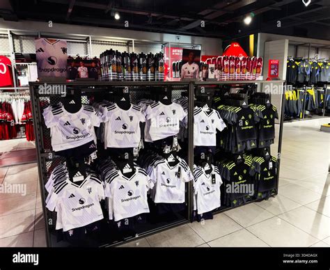 Manchester, UK - September 30, 2025: Retail display featuring Manchester United jerseys in white ...
