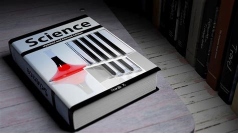 Hardcover book on science with illustration on cover on wooden surface ...
