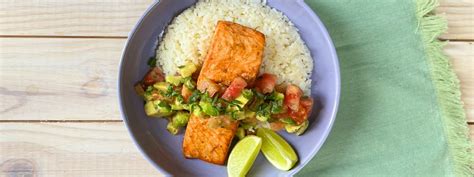 Close-up on salmon fillet with fruit salsa, over rice.