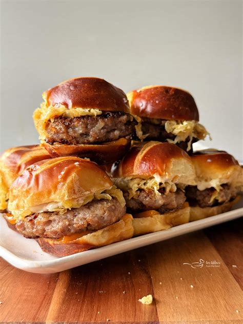 Bratwurst Sliders with Mustard Kraut on Pretzel Buns